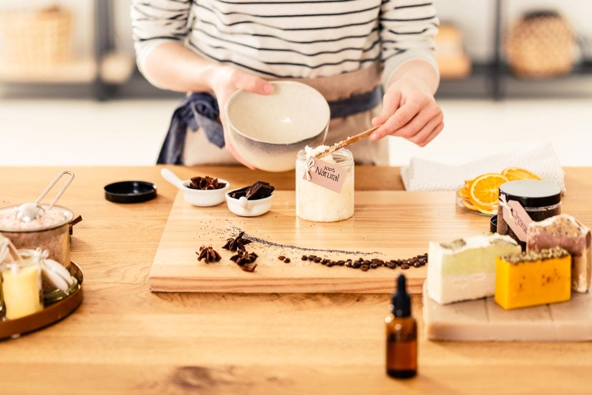 Preparing homemade natural skincare products with ingredients.