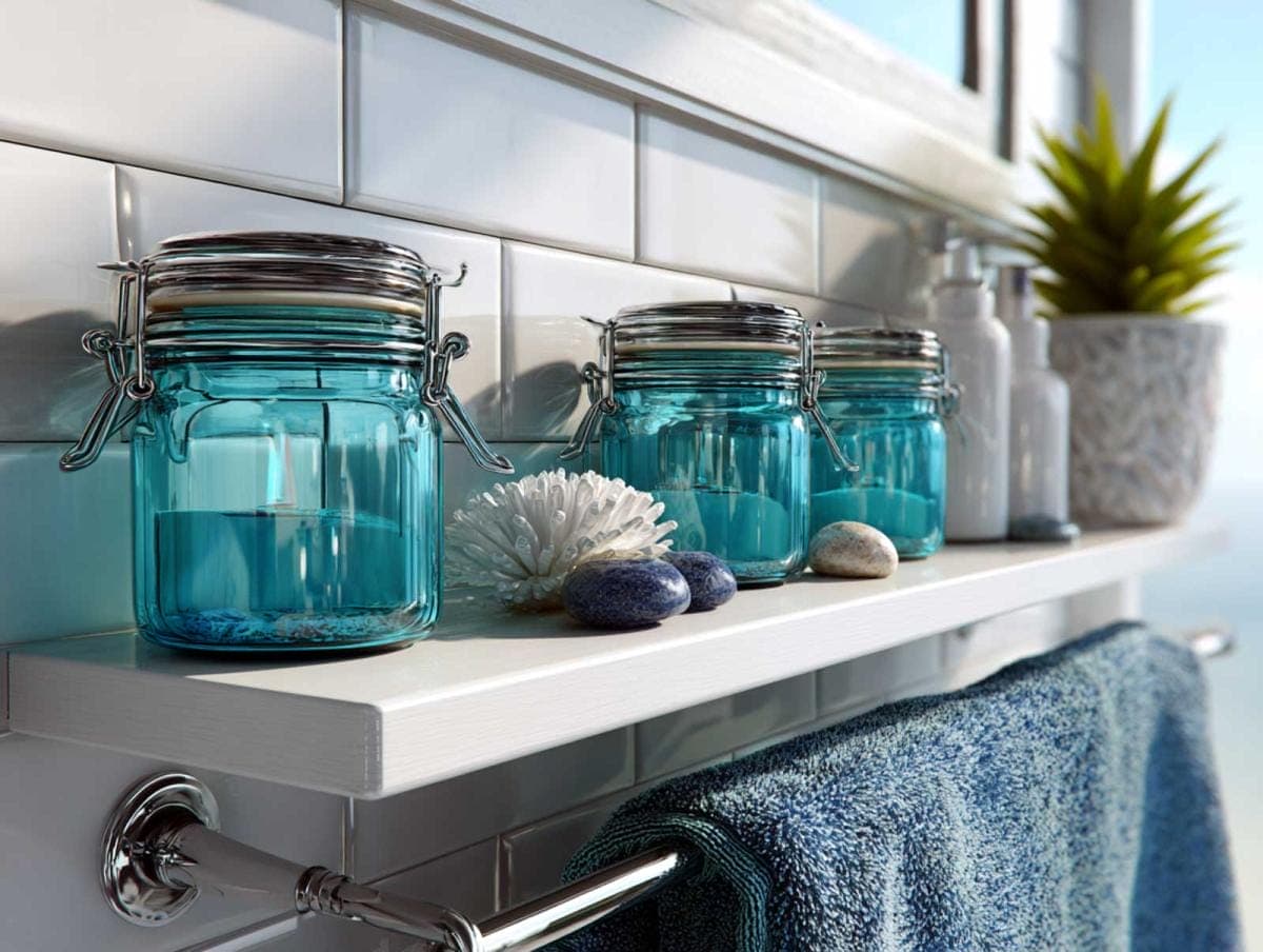 Bathroom shelf with blue jars and decor items.
