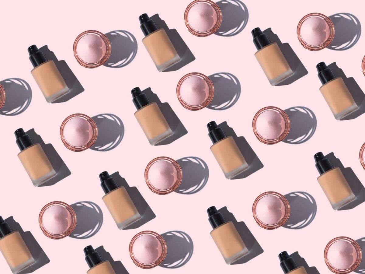 Foundation bottles and blushes on pink background