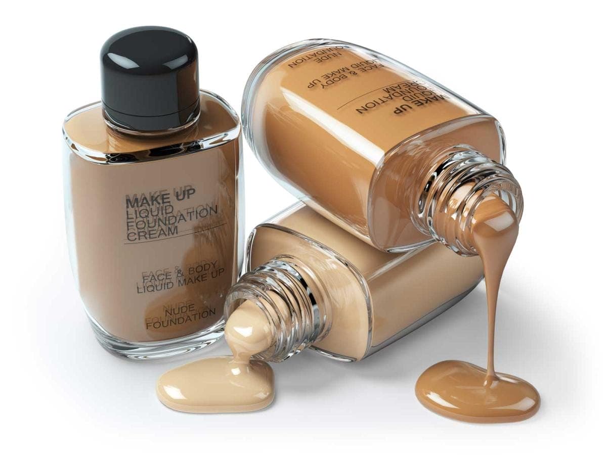 Liquid foundation bottles with makeup spilling out.